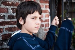 Juvenile male holding onto a fence. 